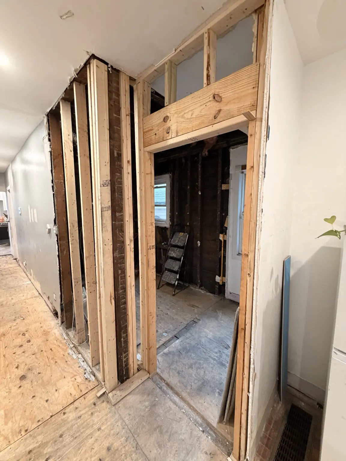 Framed doorway and wall opening under renovation